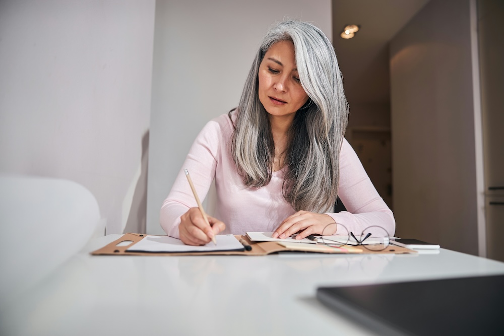Grey haired woman checking her finances